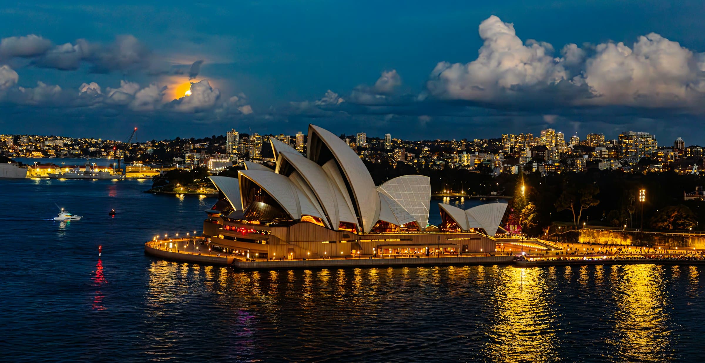 Sydney Opera House and harbour illuminated at night